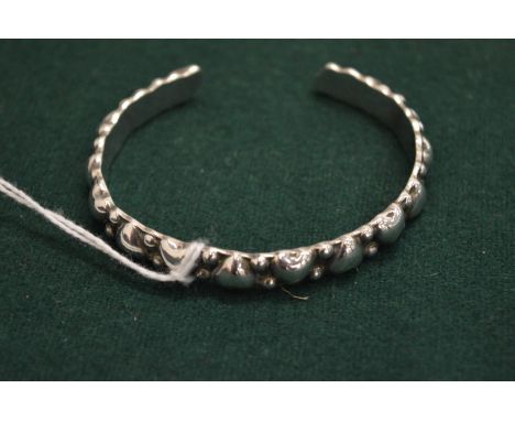 A silver bangle.