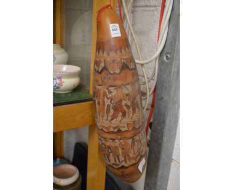A carved gourd shaped musical instrument or vessel.
