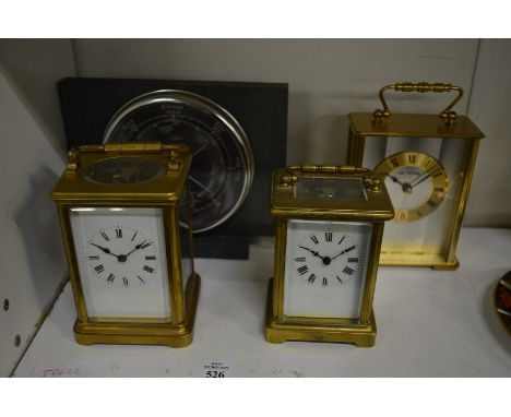 Three carriage clocks and a barometer.