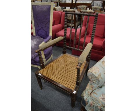 A 19th century bobbin turned armchair with cane work seat.
