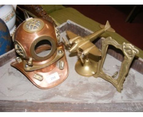 Miniature brass diver's helmet, photo frame and brass model twin engined aeroplane