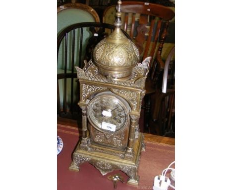 A Middle Eastern brass mantel clock with striking movement, standing 52cm high overall