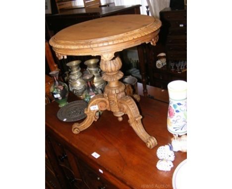 A continental carved wood tripod low occasional table