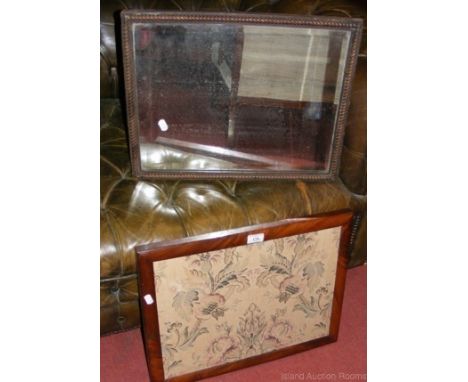 Hanging bevelled wall mirror in hand carved oak frame and a mahogany framed pole screen tapestry