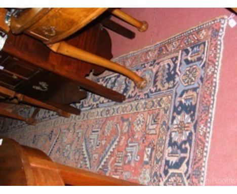 A 330cm x 250cm red ground Middle Eastern carpet