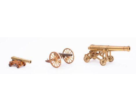 A 9 1/2 inch brass scale model cannon barrel on brass skeletal garrison carriage: together with a 5 1/4 inch barrel on  a nav