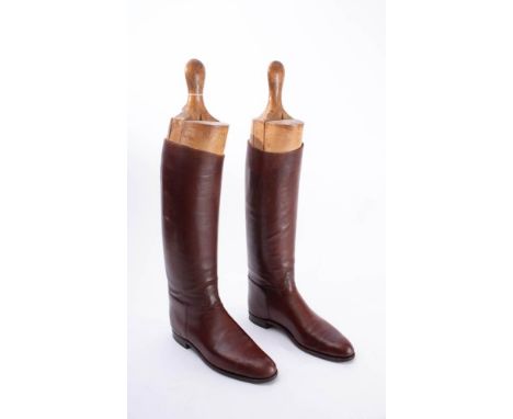 A pair of brown leather riding boots: (possibly a size 8), together with a pair of bone handled boot pulls, an antler handled