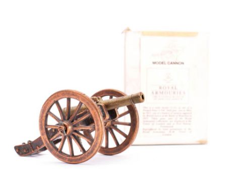 A group of various small model cannon: together with a piece of grape shot on a wooden plinth, a boxed Royal Armories model c