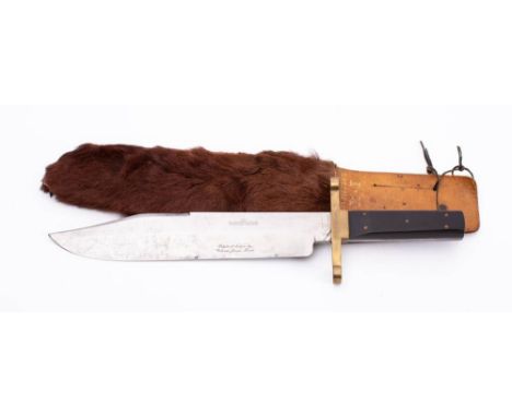 A large  'I XL' Bowie knife by G Wostenholm & Son,Sheffield: , clipped back blade , brass hilt and two piece wooden grip in a