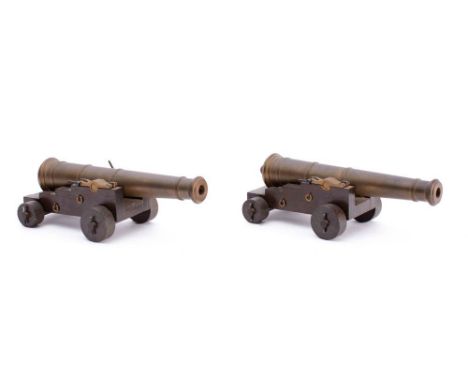 A pair of scale model cannon: the 8 1/2 inch  barrels in naval 5/5 truck with large  levered brass cap squares, 22cm long.* N