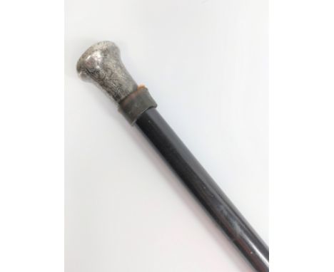 A Sterling silver topped ebonized walking stick. Circa 1900. 