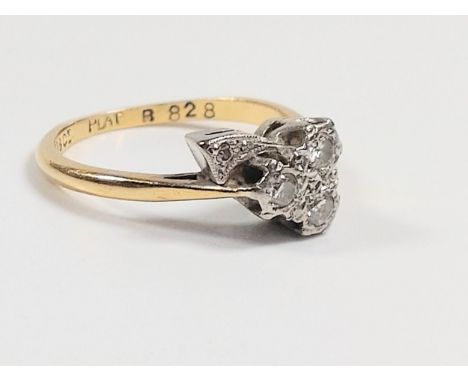 A hallmarked 18ct yellow gold with platinum head diamond leaf ring, consisting of three larger diamonds illusion set in the s