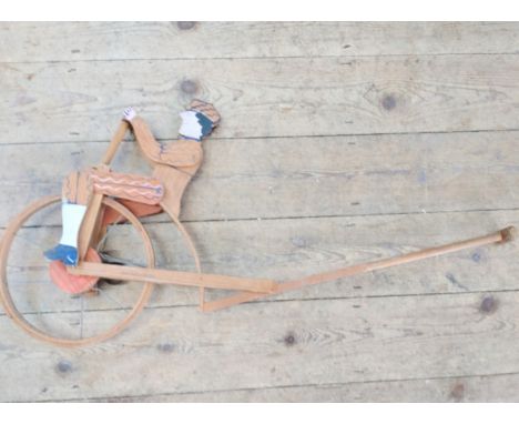 A Childs Toy. in the form of a cyclist. vintage. 
