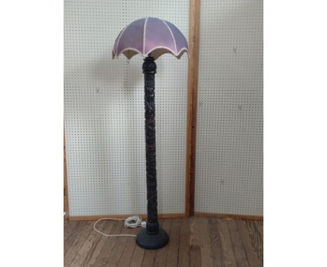 An ornately carved  standard lamp. Vintage. 