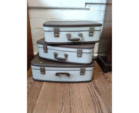 A set of three vintage suitcases. 