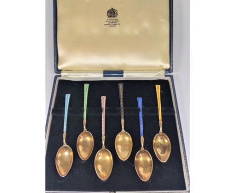 A Set of six Gilt Metal and Enamel coffee spoons. (cased) 