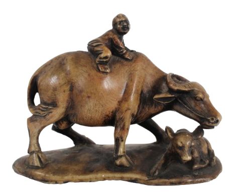 Chinese Carved Soapstone of a Boy on a Buffalo The light brown stone with stained highlights, carved to represent a boy atop 