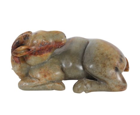 Chinese Jade Ram. The greenish gray jade with areas of russet, the ram in a recumbent pose, its head turned towards its body 