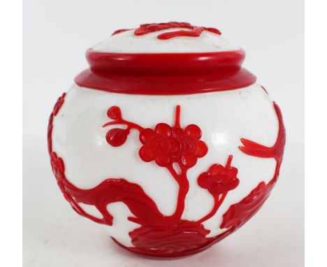 Chinese Peking Glass Covered Jar Early to mid-20th Century. The white spherical vessel with conforming cover, overlaid with r