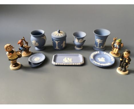 A selection of Wedgwood blue and white items including three vases, one lidded pot, three plates and two trays, together with