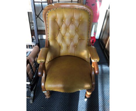 An Edwardian leather upholstered, button back chair.