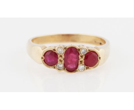 A 9ct yellow gold ruby and diamond ring, set with three principal graduated oval cut rubies, interspersed with round brillian
