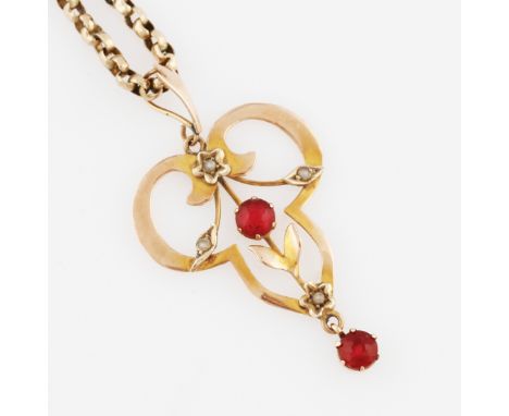 An Edwardian red paste and seed pearl pendant of open metalwork design, stamped 9ct, on a belcher link chain, stamped 9c.