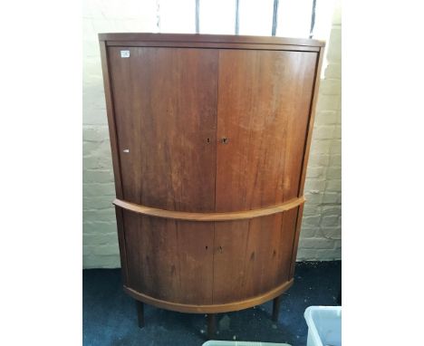 A teak four door corner cupboard