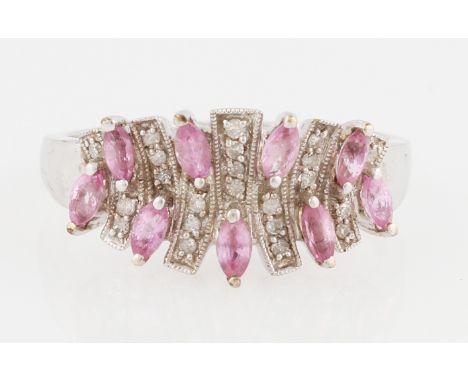 A 9ct white gold pink sapphire and diamond dress ring, set with marquise cut pink sapphires interspersed with diamond accents