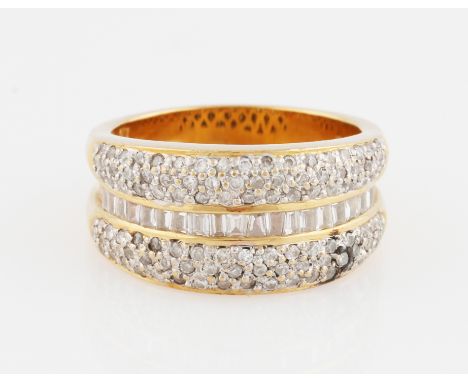 An 18ct yellow gold diamond half eternity ring, set with a central row of graduated tapered baguette cut diamonds, flanked to