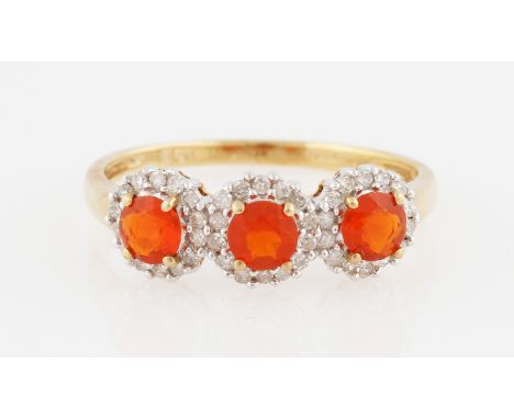 A 9ct yellow gold fire opal and diamond ring, set with three round cut fire opals surrounded by eight-cut diamond accents, ha