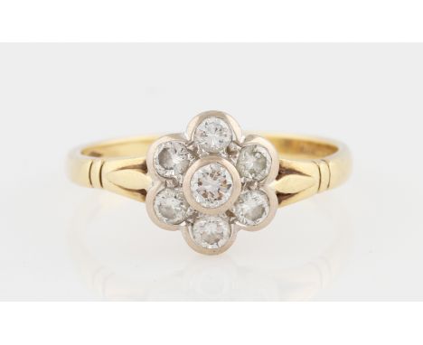 An 18ct yellow gold diamond flower cluster ring, set with a central round brilliant cut diamond, measuring approx. 0.15ct, su