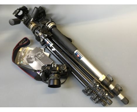 A Canon A-1 DSLR Camera with MA Motor Drive attached, with a Canon FD 50mm 1:1.8 auto bellows lens and hood (instruction manu