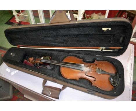 A cased violin and bow, labelled Stradivarius, with accessories