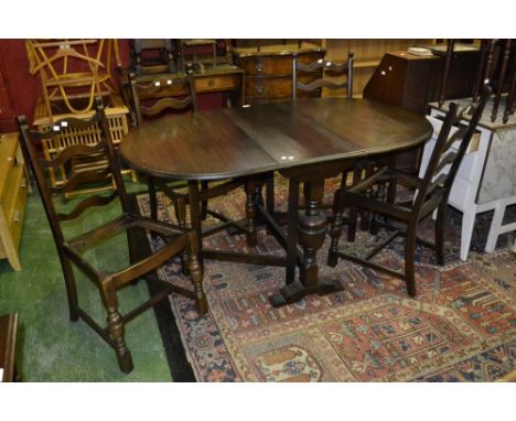 A mid 20th century dining room suite, compromising oak gateleg table and a set of four oak ladder back chairs (5)