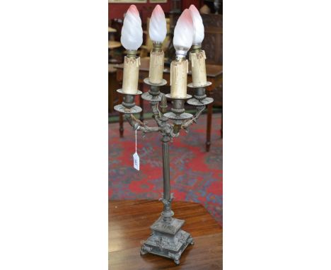 A bronzed metal four branch classical table lamp, candle bulbs, reeded column, stepped base