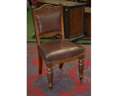 An Edwardian mahogany hall chair, shaped and carved top rail, scrolling terminal to fluted uprights, padded back and seat, tu