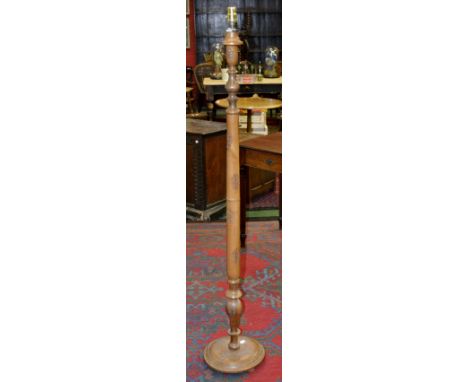 An Asian carved standard lamp