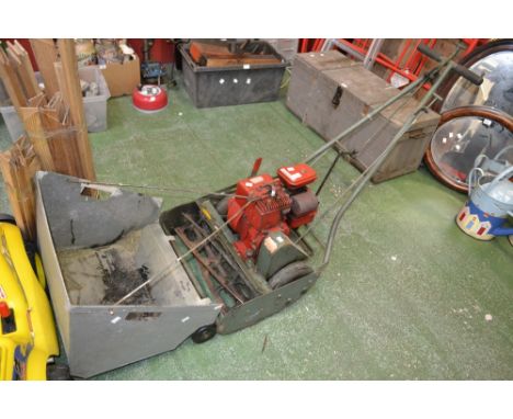 A Trimmer petrol lawn mower, three horse power, Briggs and Stratton engine, 20inch with grass box 