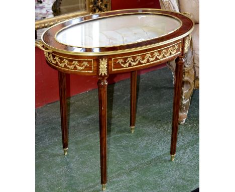 A contemporary Louis XVI style kingwood  tray top bijouterie table, oval glass top, button upholstered interior, turned and f