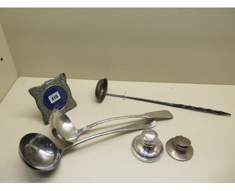 Two silver weighted capstan inkwells, one missing an insert and dented, a Georgian silver wine ladle, a silver collared baton