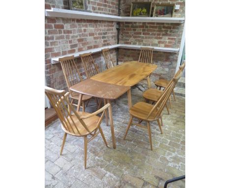 A blonde elm Ercol dining table, 71cm tall x 152cm x 75cm with separate extension which extends it to 199 cm and 8 stick back