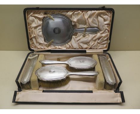 A boxed silver backed 5 piece dressing table set (no comb) Chester 1921/22, 1922/23 Robert Pringle and Sons, some denting and