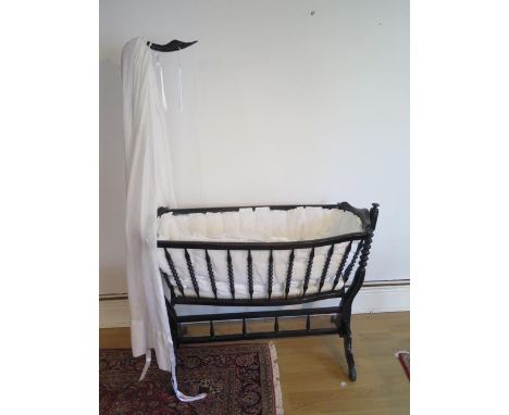 A Napoleon III swan neck bobbin turned cradle on stand with covers, 161cm tall x 120cm 