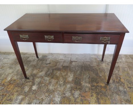 A circa 1900's mahogany Heals and Son side table with 2 frieze drawers tapering legs, caps and castors, 77cm tall x 117cm x 5