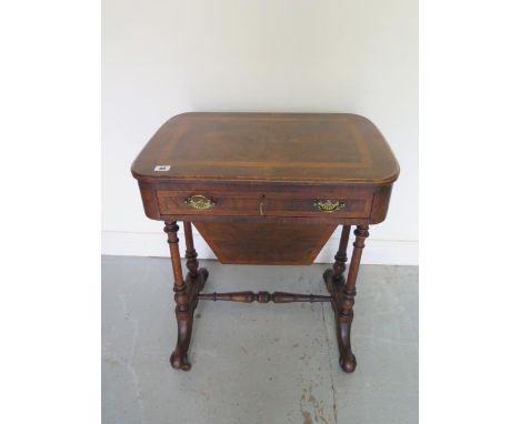 A Victorian walnut work box with a drawer above a basket on twin pillar supports, needs some restoration but reasonably good 