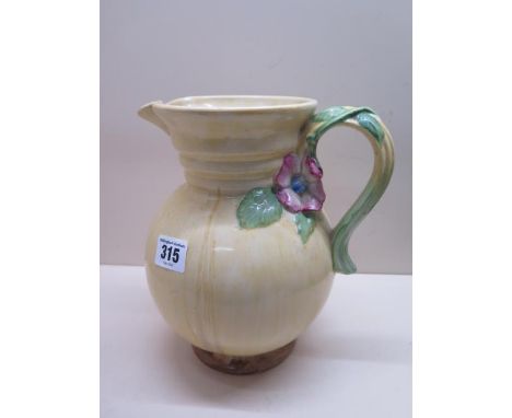 A Clarice Cliff relief decorated jug, 22cm tall, in good condition 
