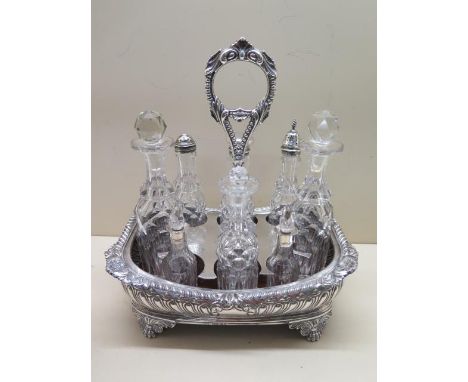 An imposing 8 piece Regency style George IV silver cruet, hallmarked 1825, John James Keith, London, of curved rectangular fo