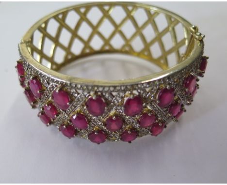 A ruby and white spinel 925 silver gold plated cuff bangle, 6.5cm x 7cm x 3cm, in good condition 