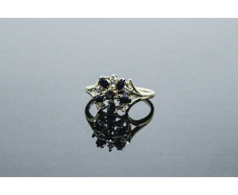 A 10ct gold diamond and sapphire cluster ring, 2.8g, size N/O.